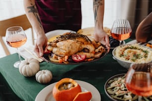 a person holding a plate of food on a table