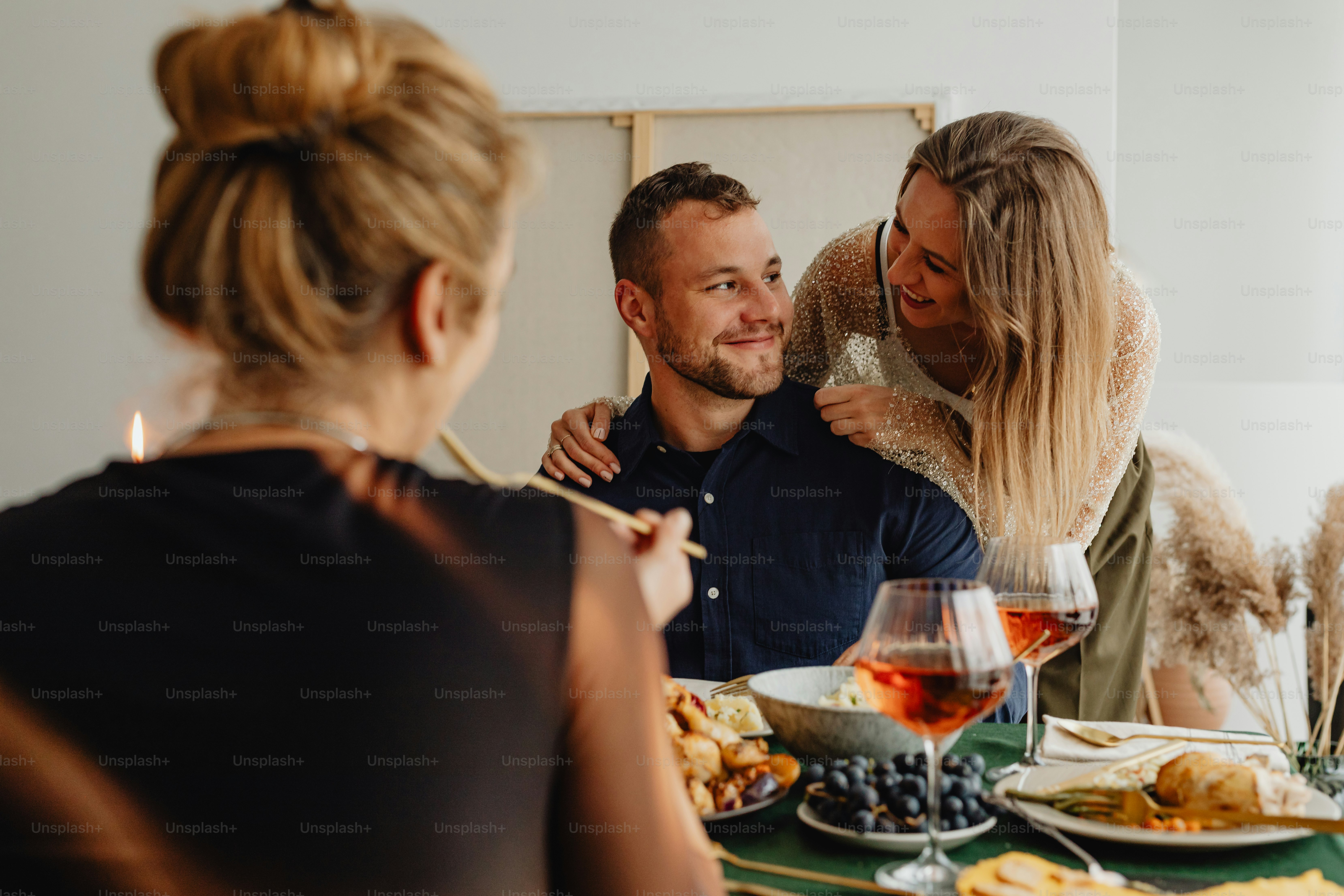 a man and a woman sitting at a table with food