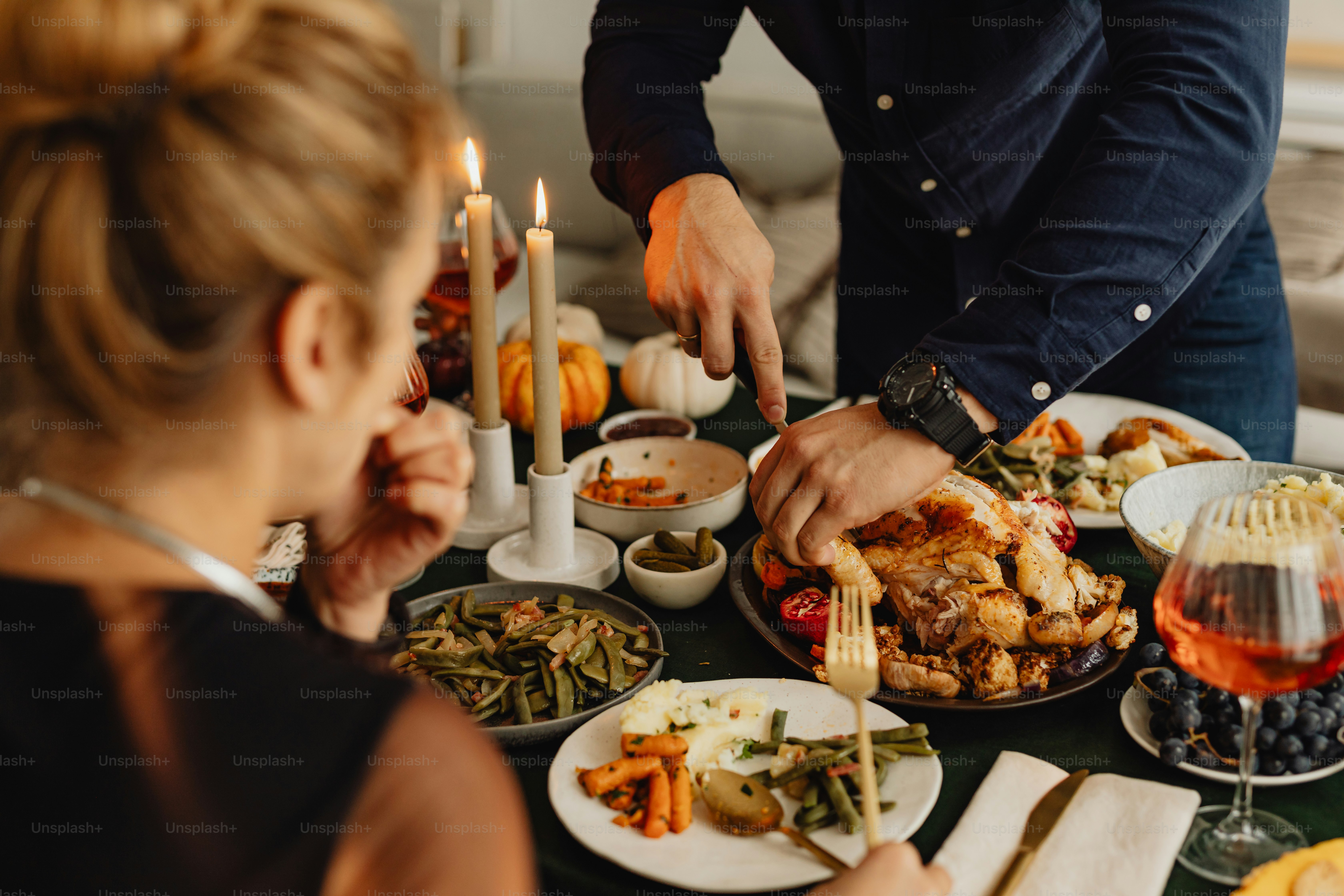 a group of people sitting around a table with plates of food