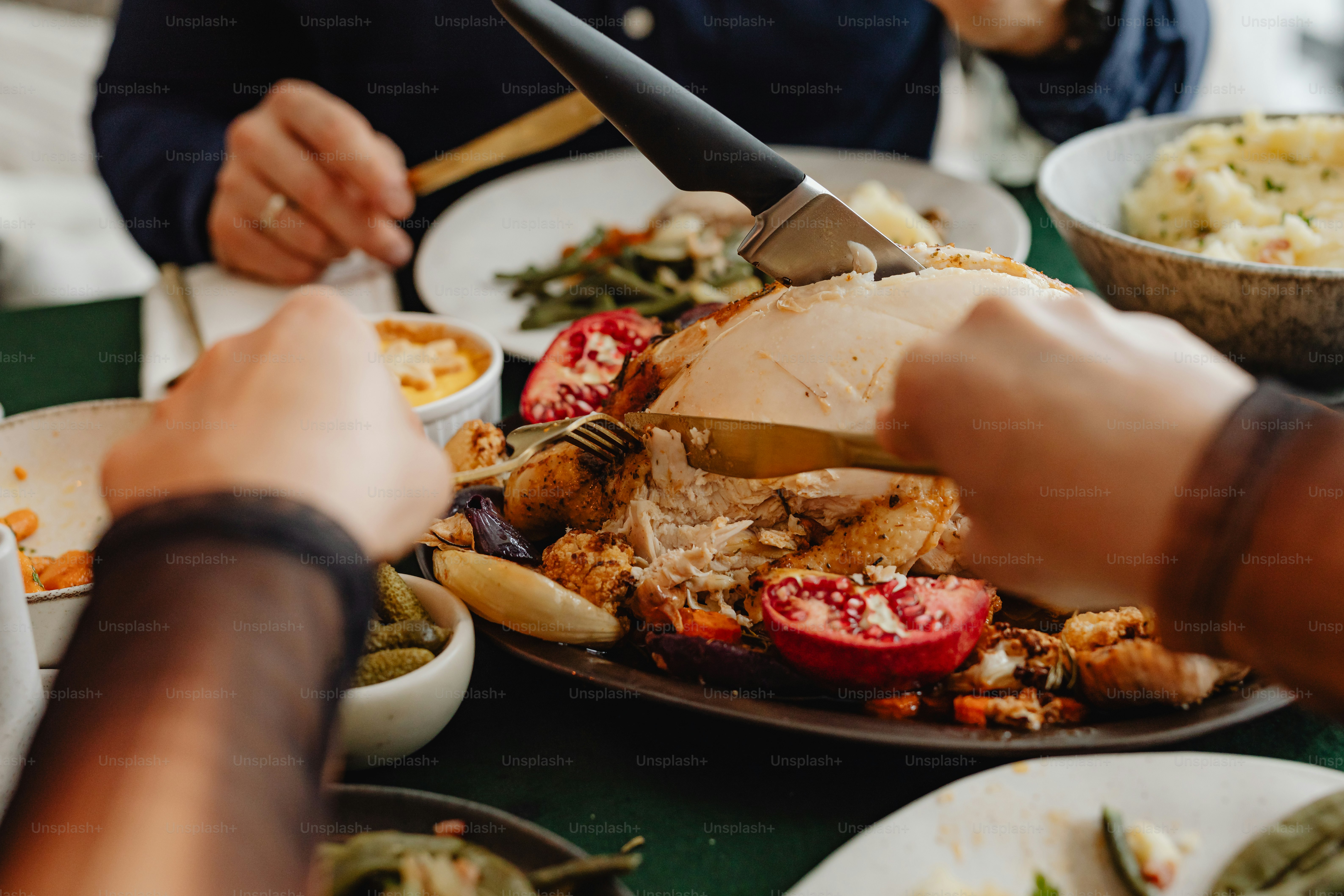 a person cutting a turkey on a plate