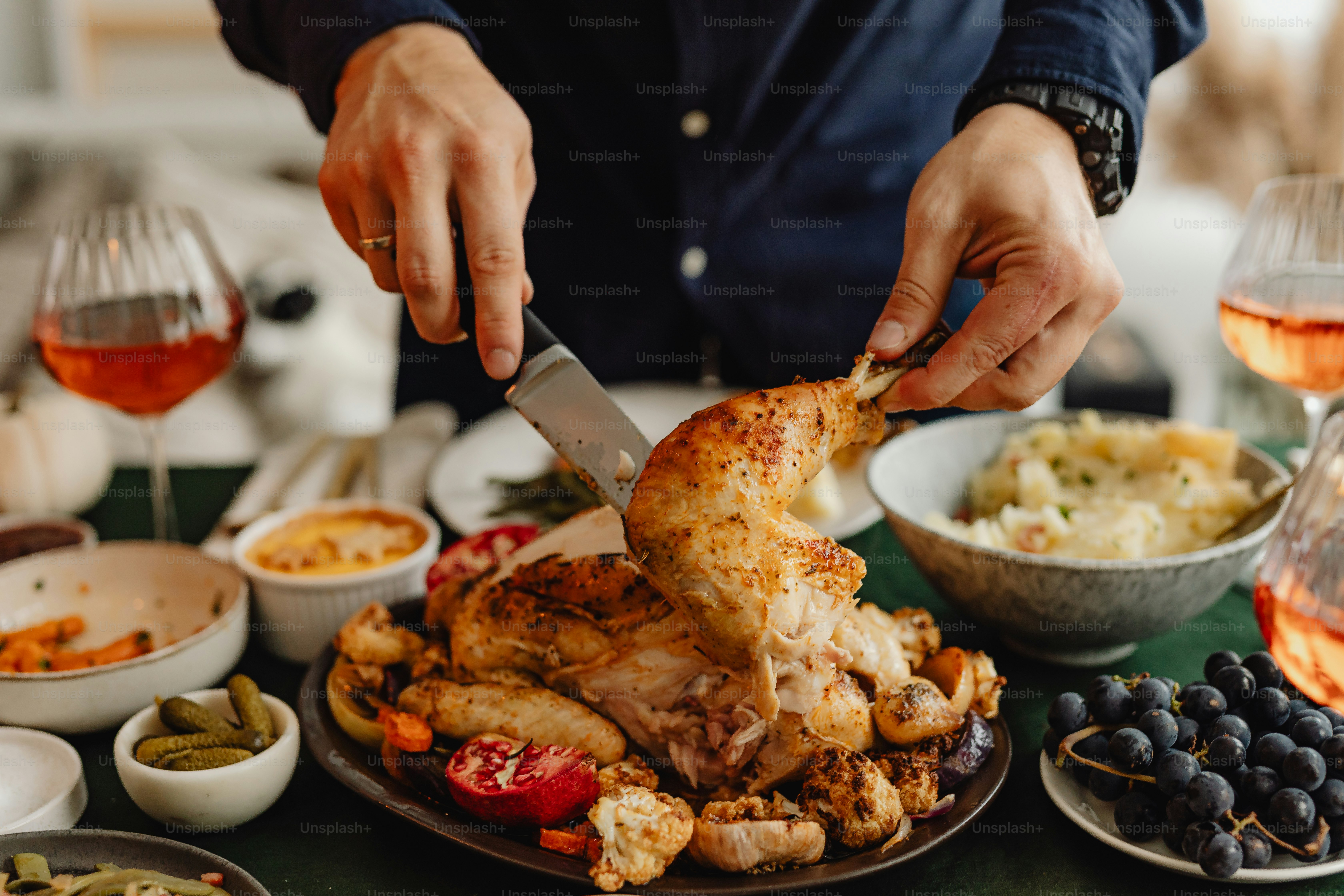 a person is cutting a chicken on a plate