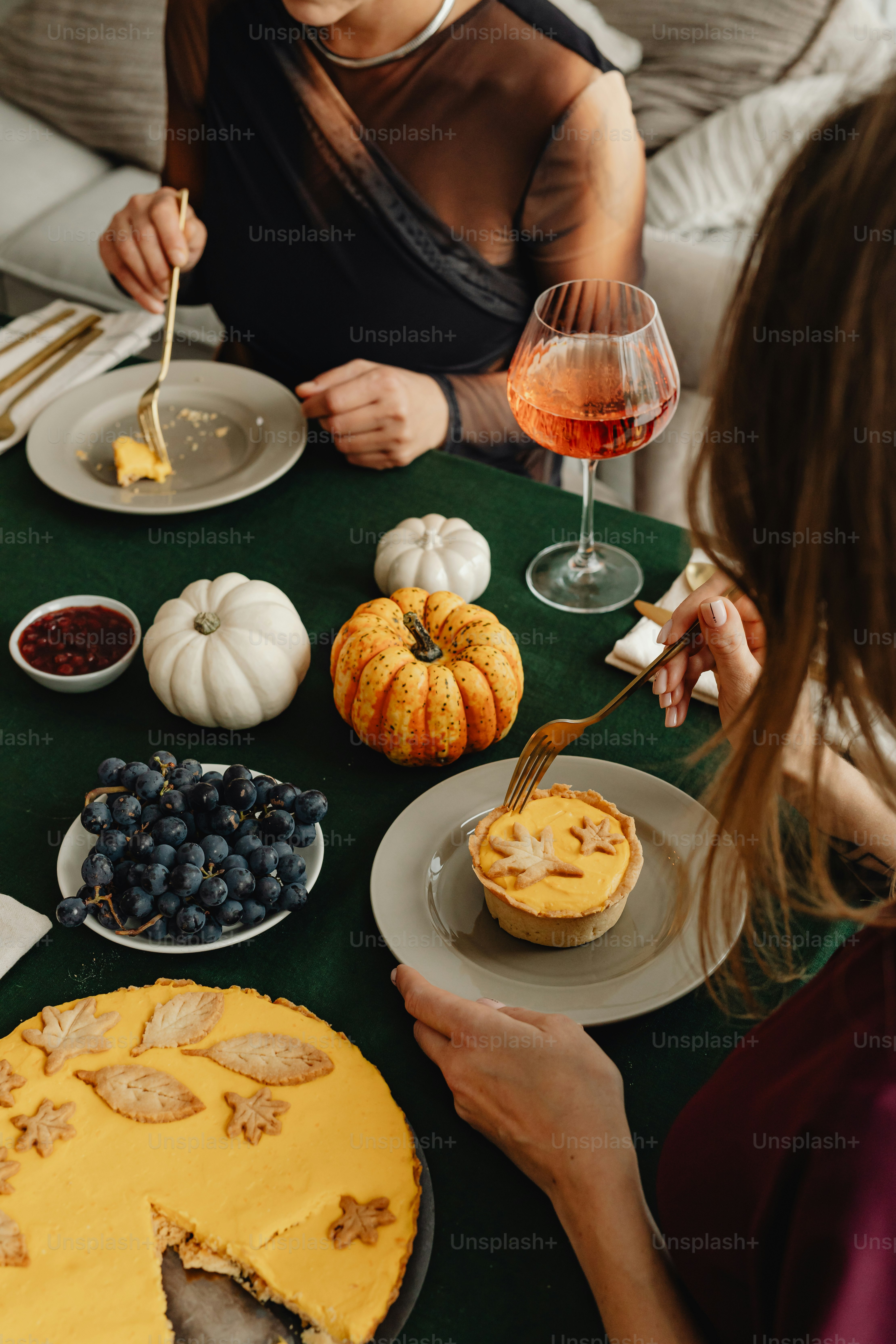 A group of people sitting around a table with plates of food photo ...