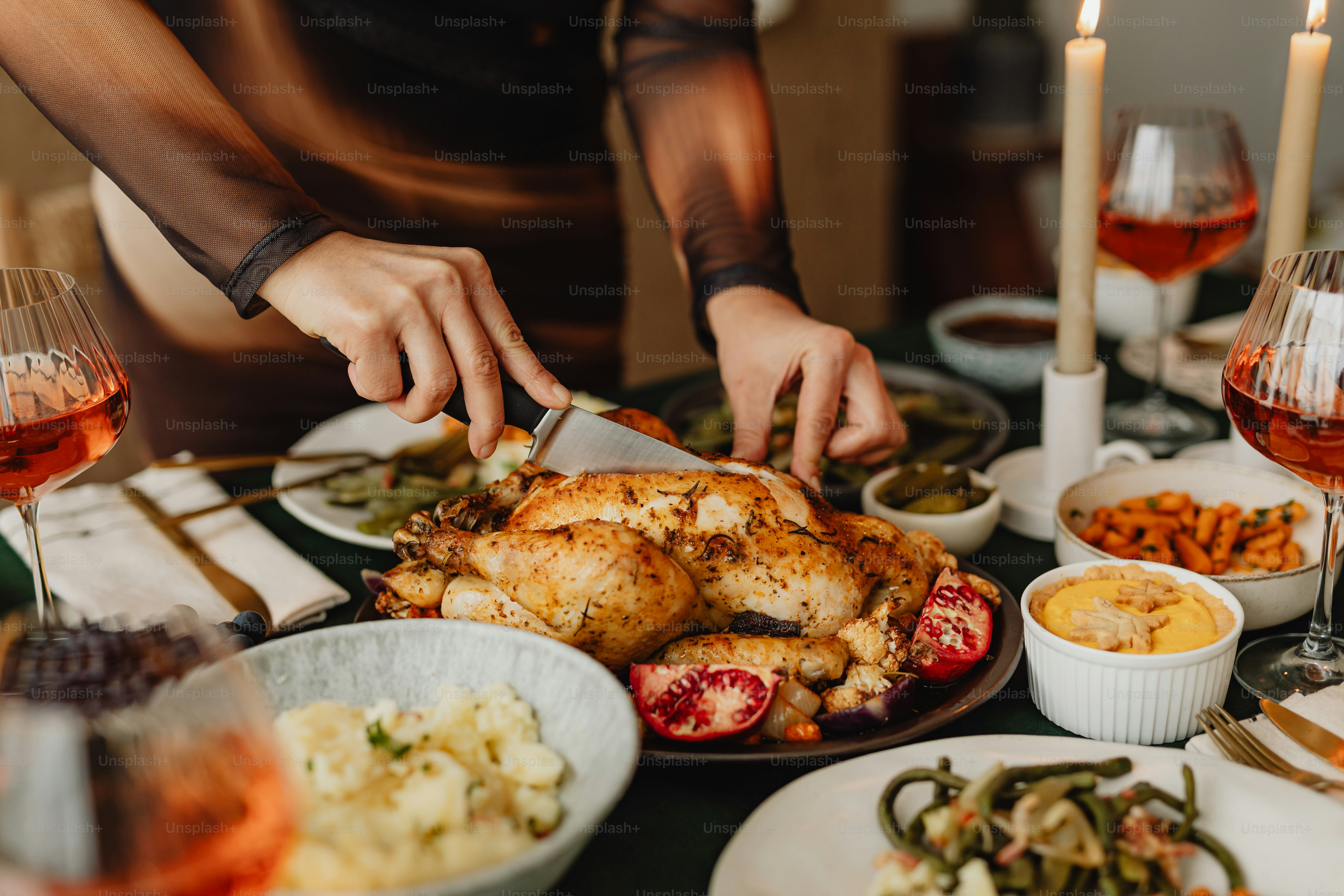 a person cutting a turkey on a table