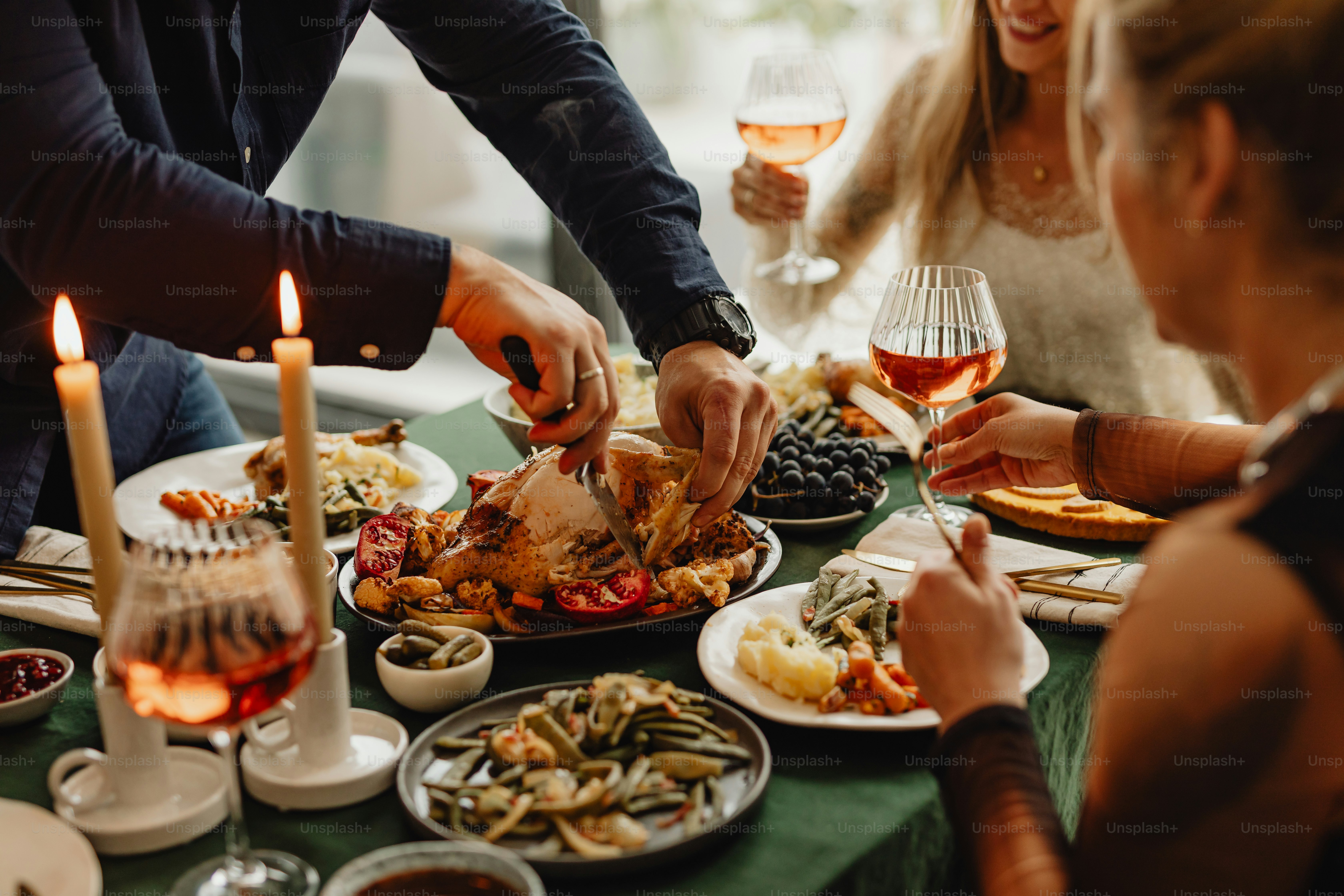 a group of people sitting around a table with plates of food
