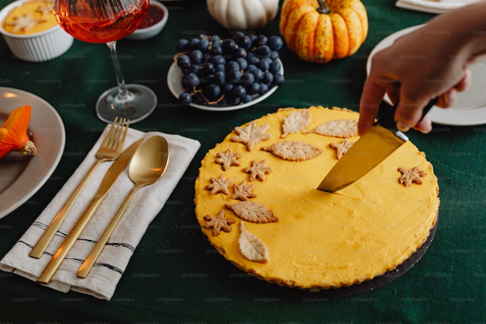 a person cutting a cake with a knife