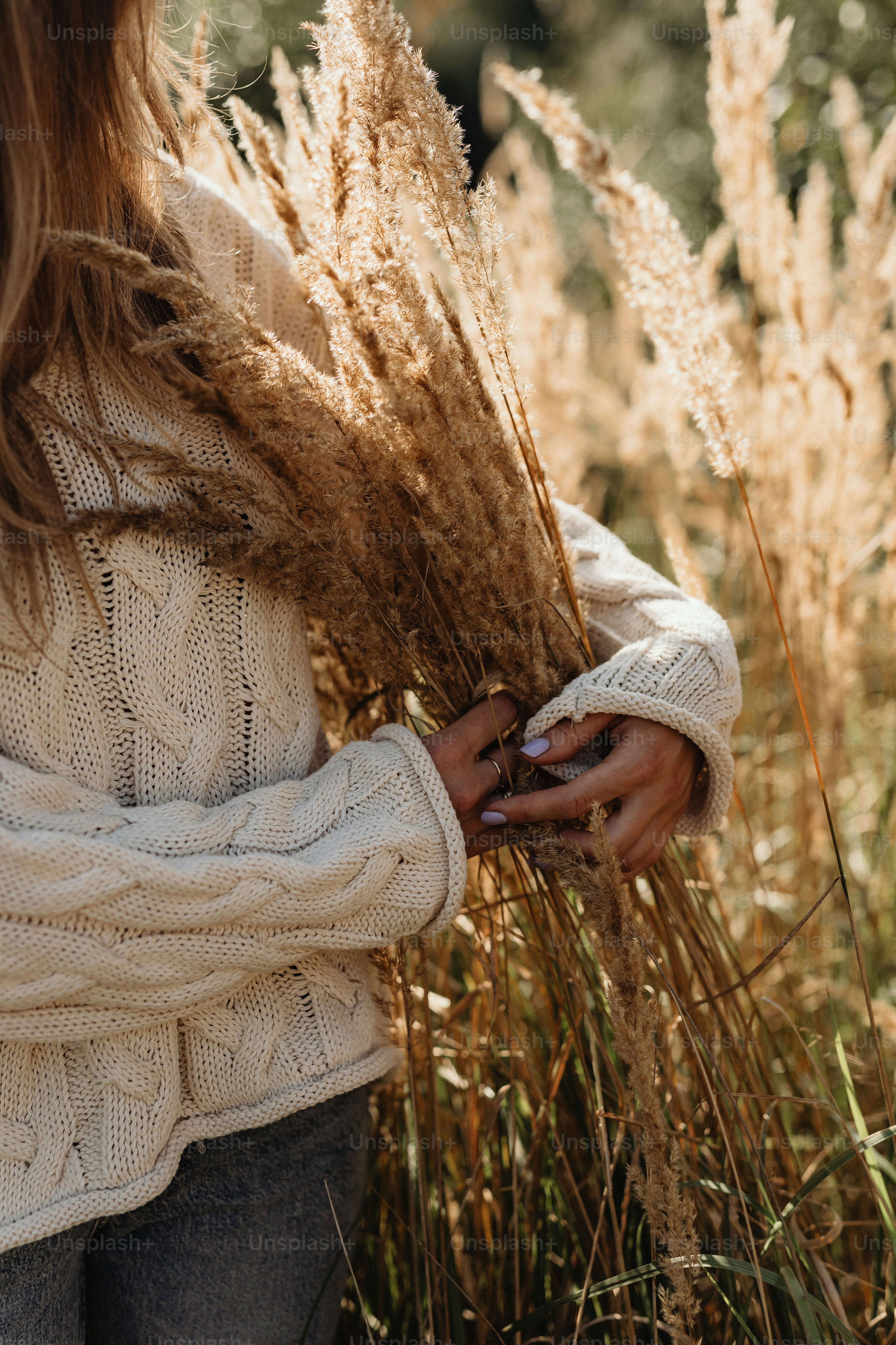 a woman standing in a field of tall grass