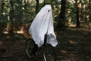 a ghost riding a bike in the woods