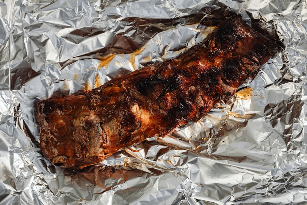 a piece of meat sitting on top of aluminum foil