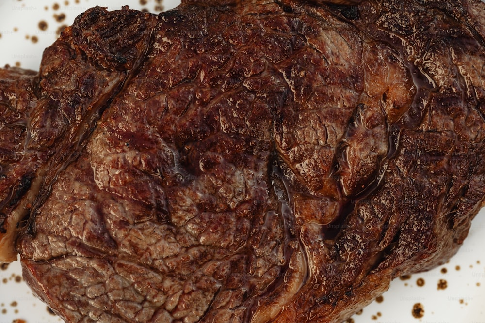 a close up of a steak on a plate