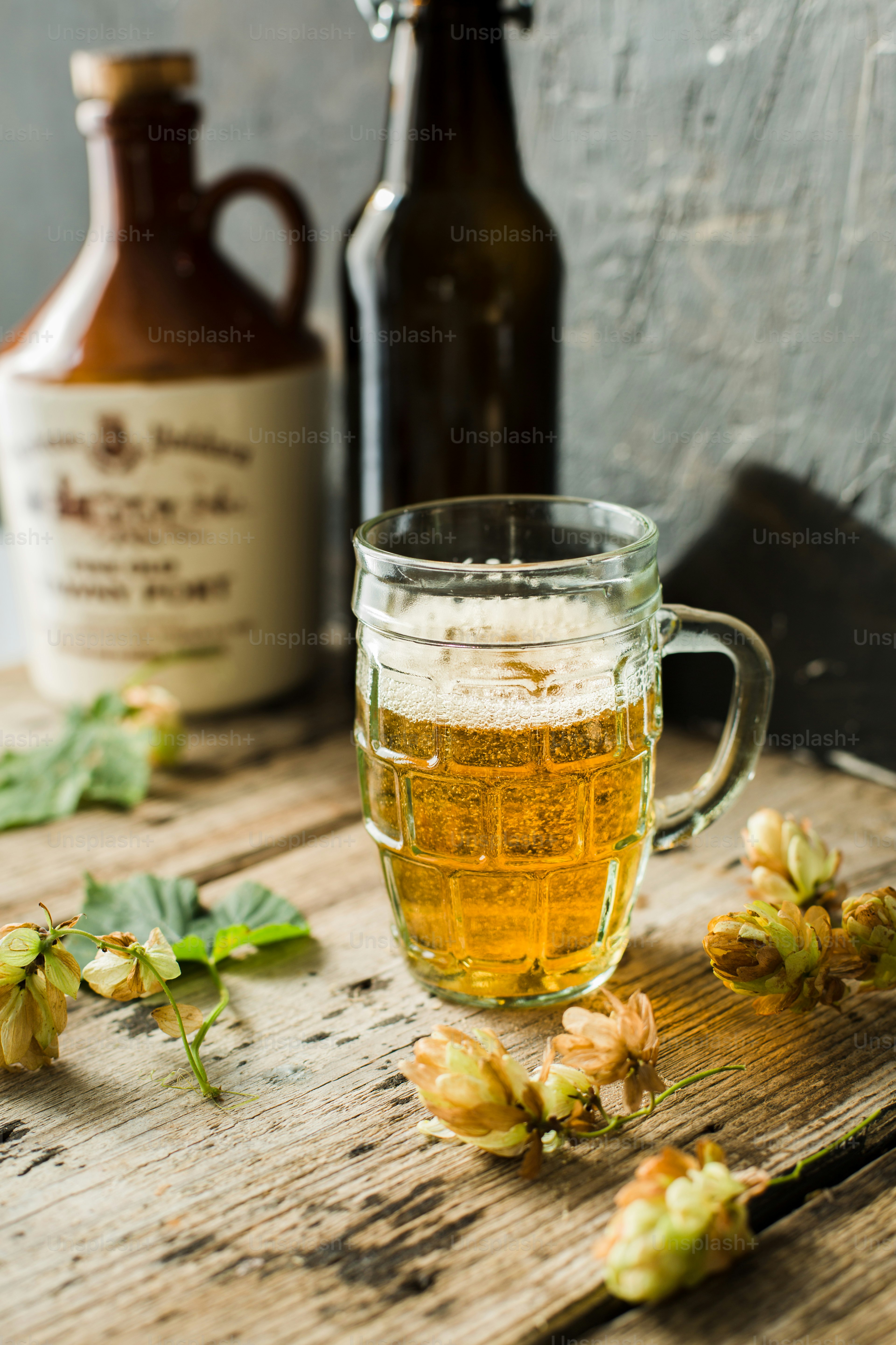 a glass of beer next to a bottle of beer