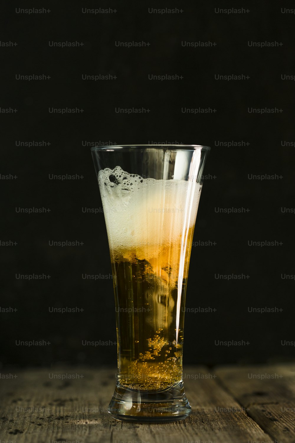un verre rempli de liquide posé sur une table en bois