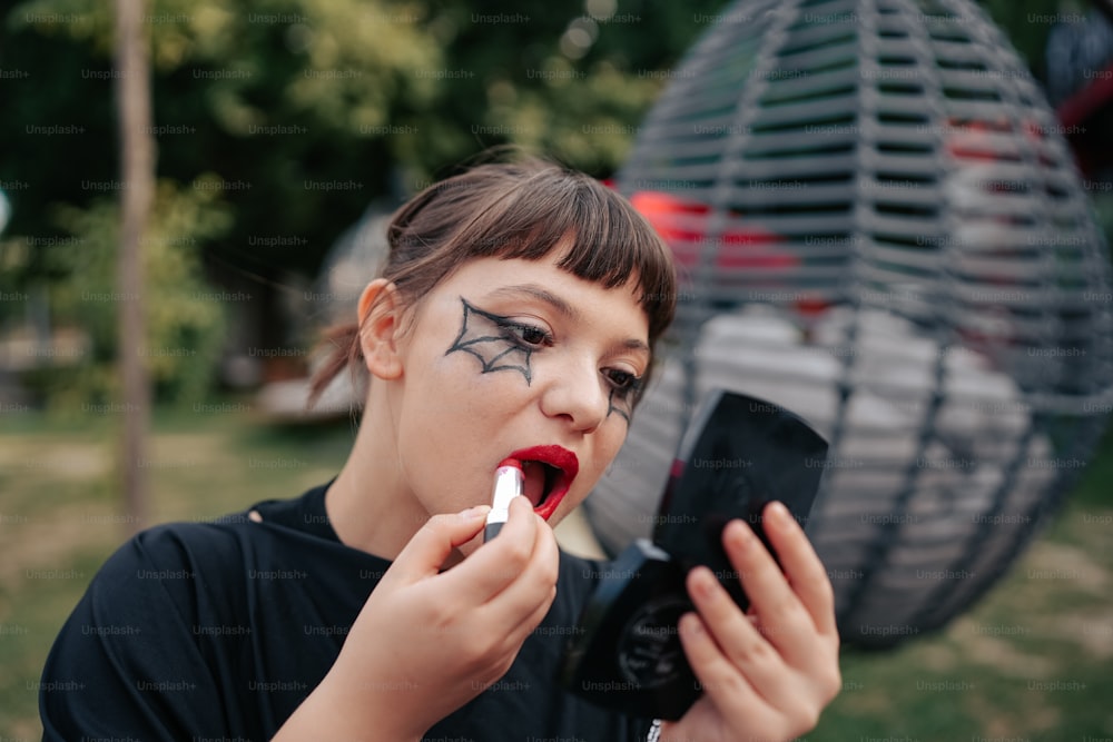 a woman with makeup on her face is using a cell phone