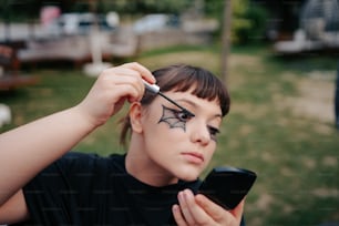 a woman with a spider painted on her face