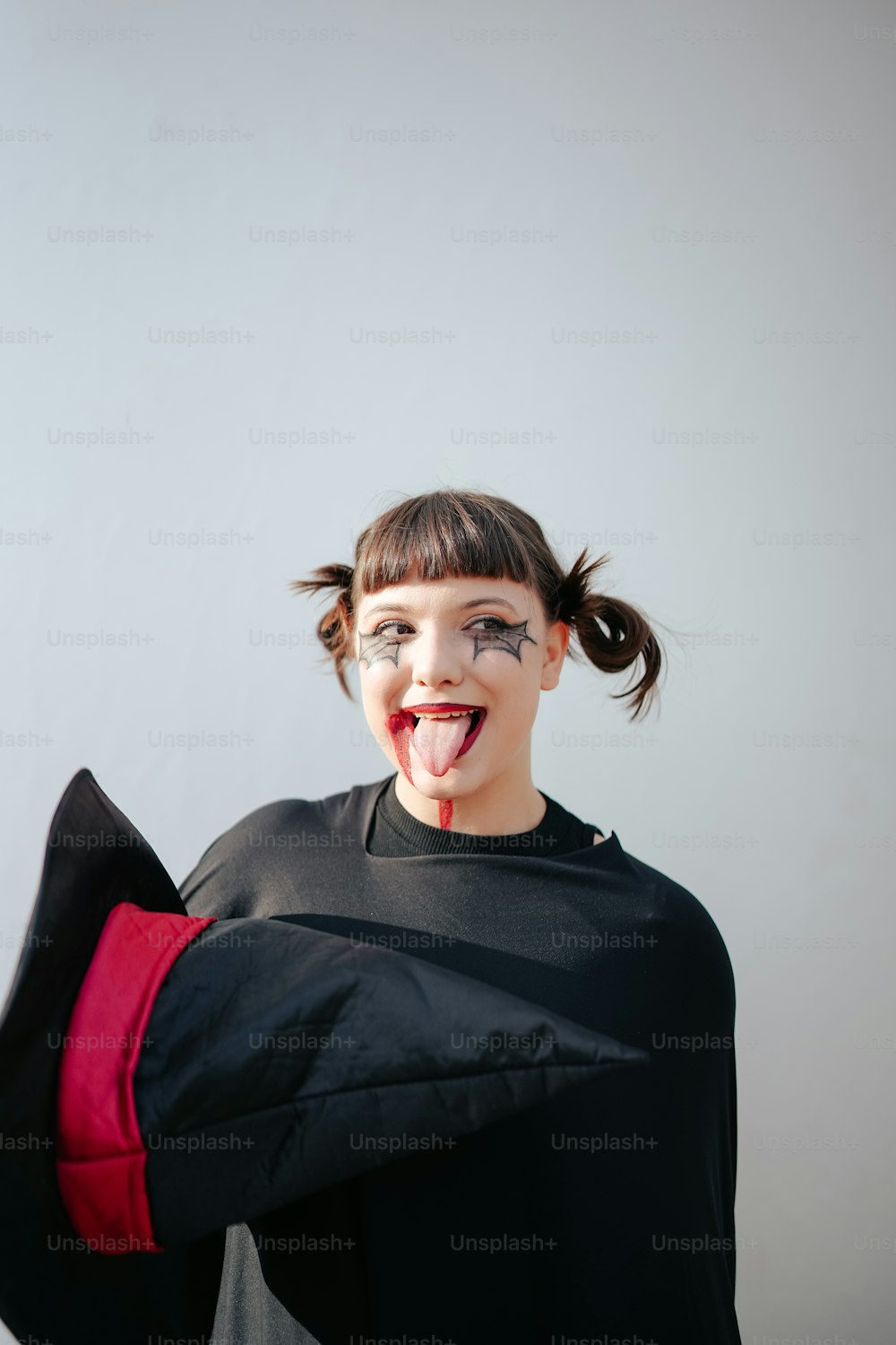 a woman with her tongue out and a black shirt