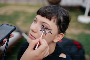a young girl with a spider painted on her face