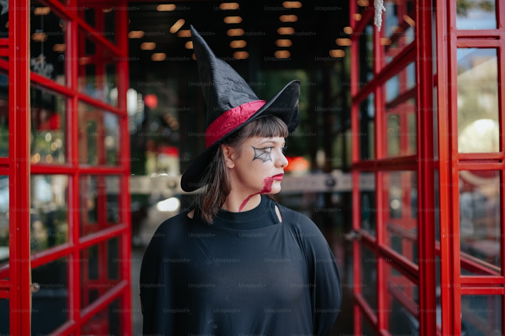 a woman wearing a witches hat and makeup
