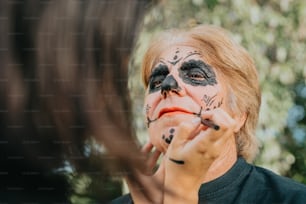 a woman is getting her face painted