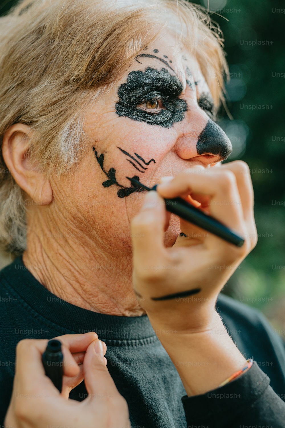 a woman with a cat face painted on her face