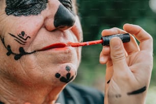 a man with face paint on his face and nose