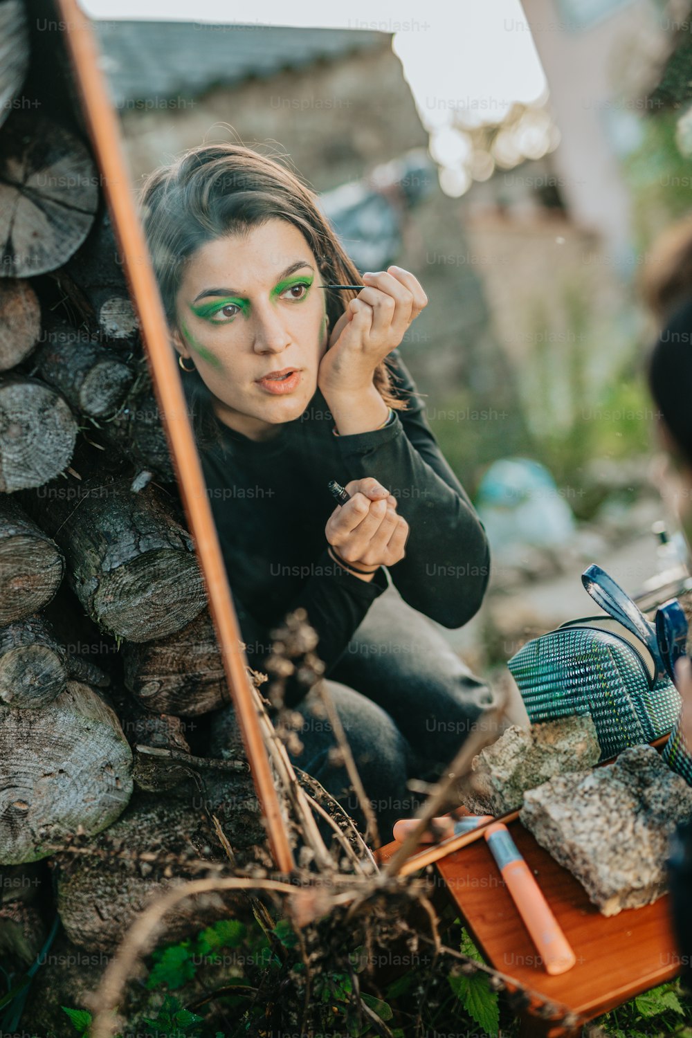 a woman with green makeup is looking in a mirror