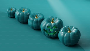 a row of pumpkins with faces painted on them