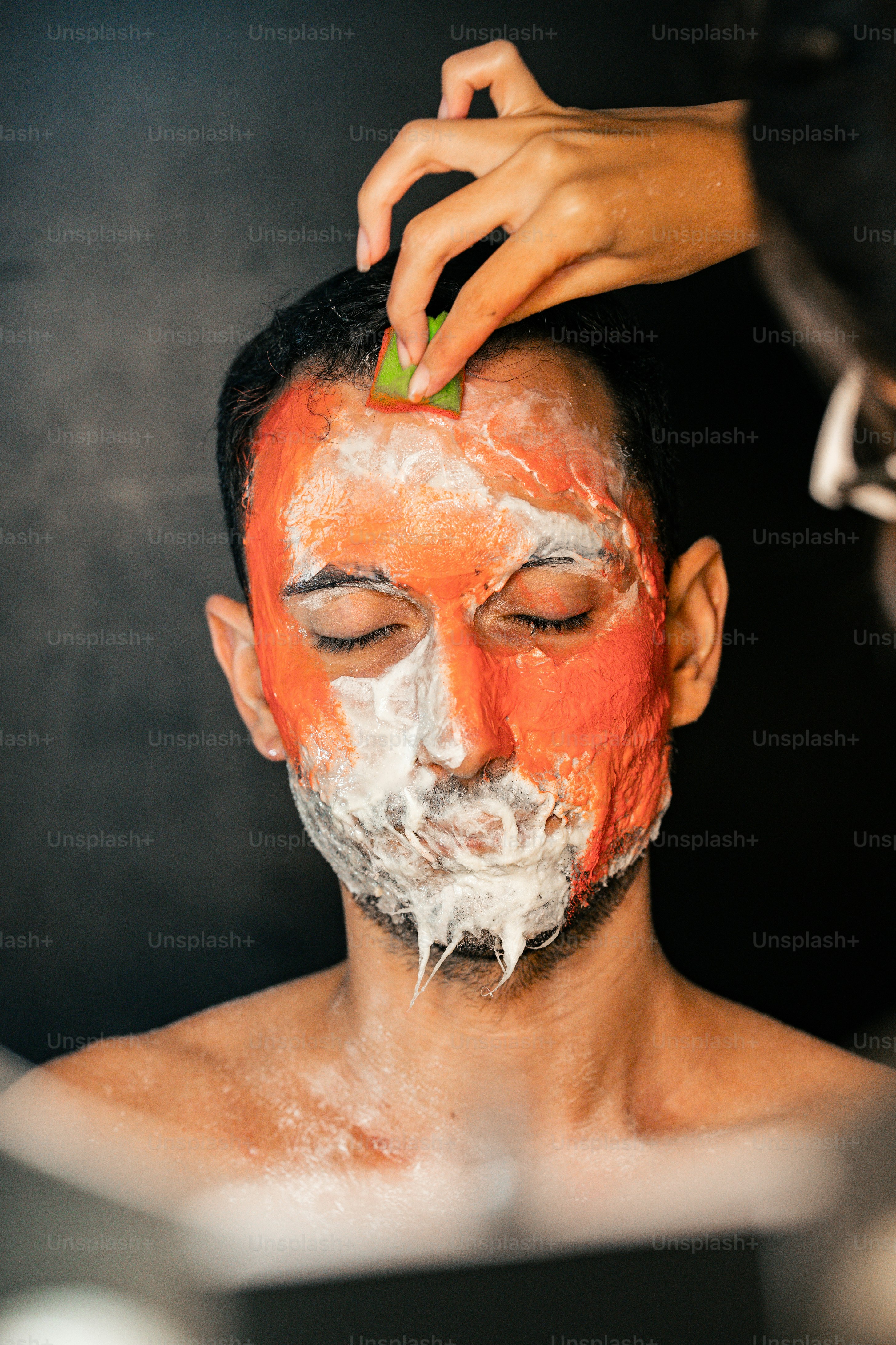 A man is getting his face painted photo – Art Image on Unsplash