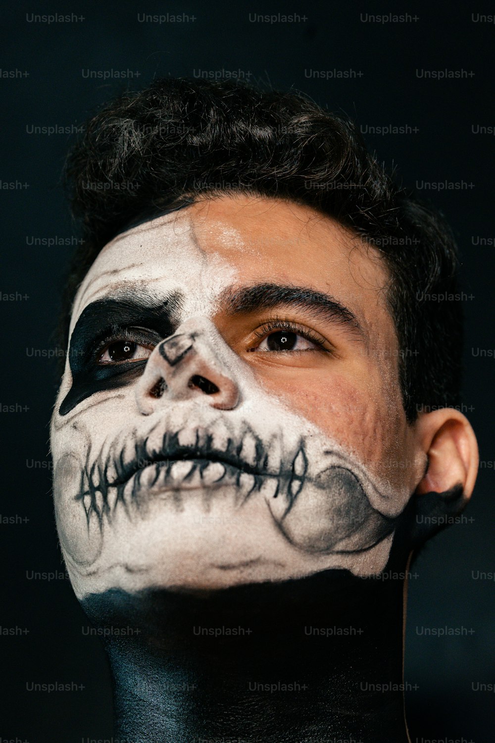 a man wearing a skeleton face paint on his face