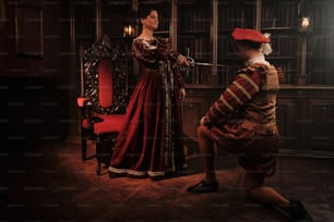 a woman in a red dress and a man in a red hat