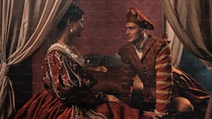 a man and a woman dressed in renaissance clothing