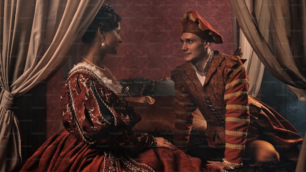 a man and a woman dressed in renaissance clothing