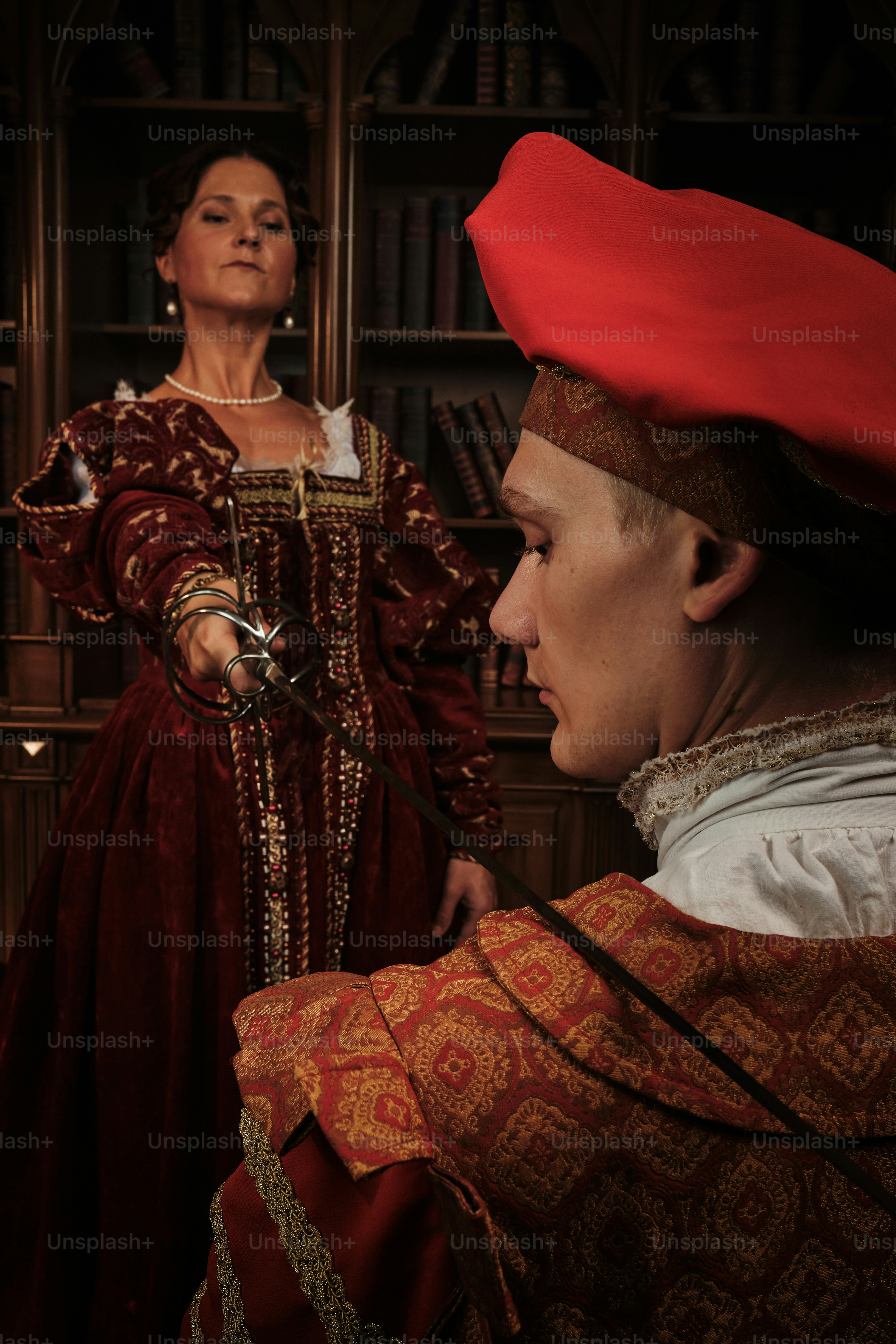 a woman in a red dress and a man in a red hat