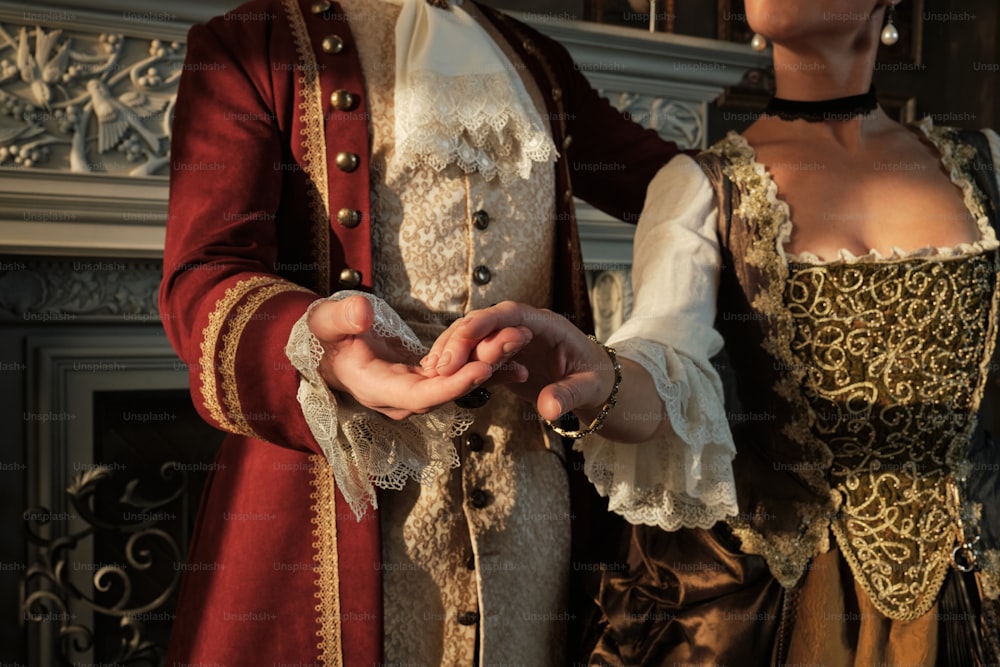 a man and a woman dressed in period costumes