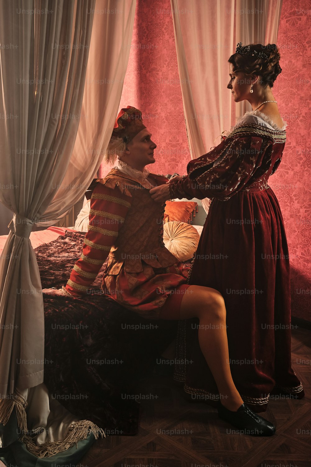 a man and a woman dressed in period costumes