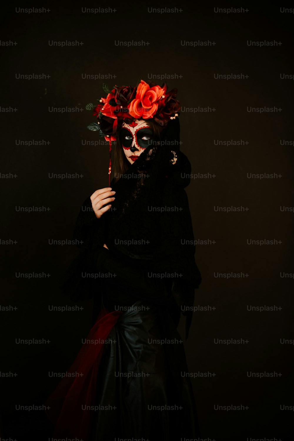 a woman wearing a mask and a black dress