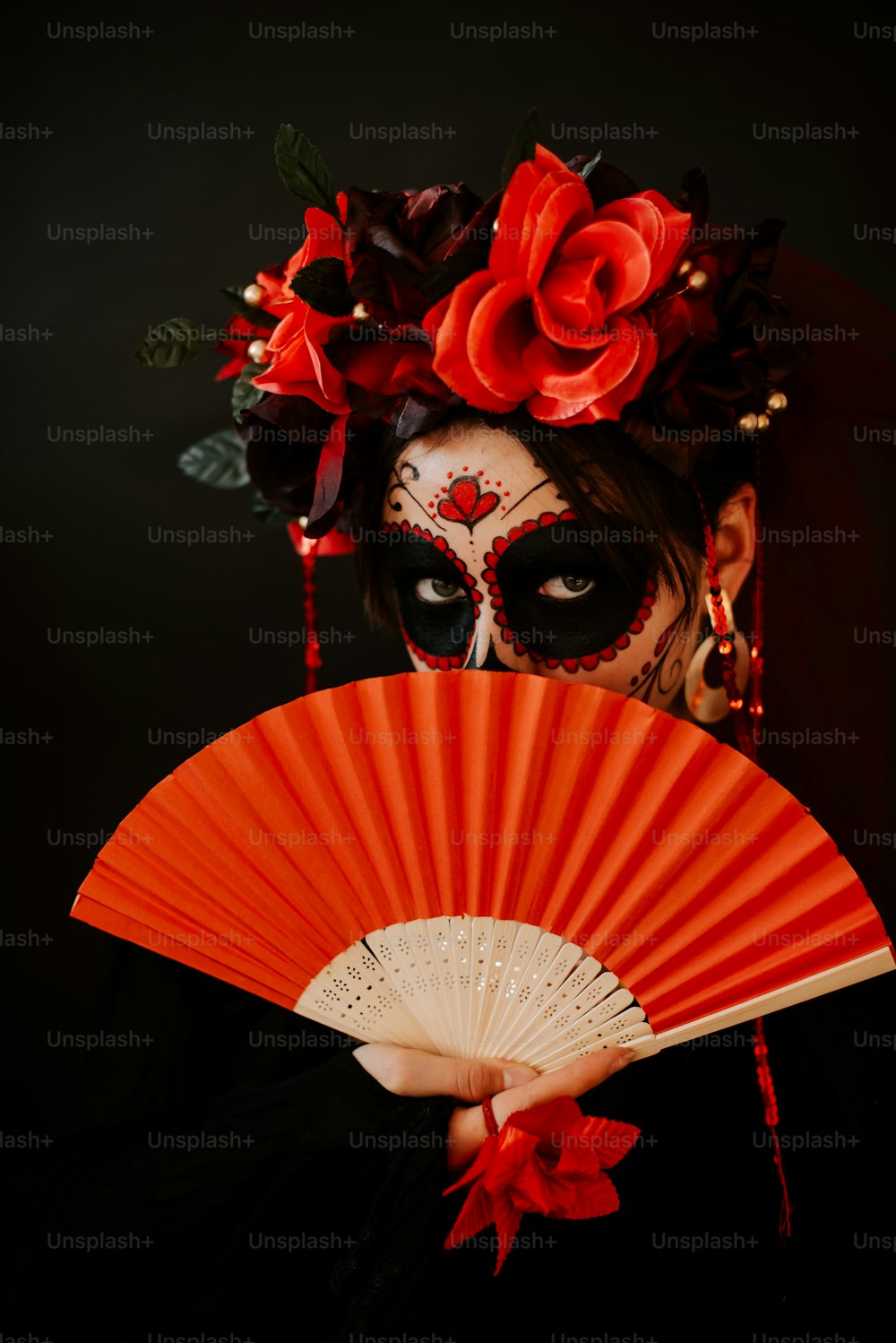 a woman with makeup and makeup art holding a fan