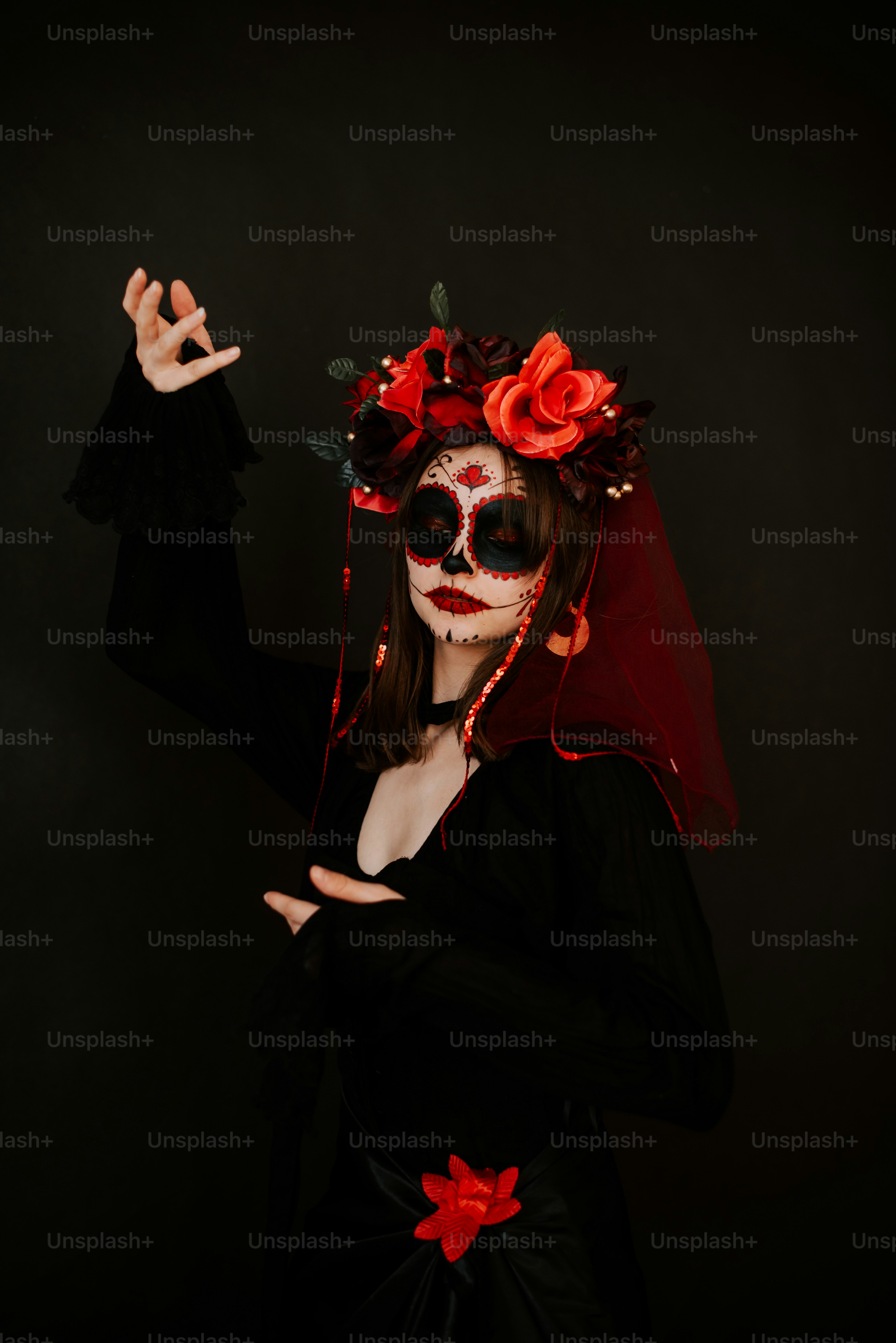 A woman in a black dress with red roses on her head photo – Halloween ...