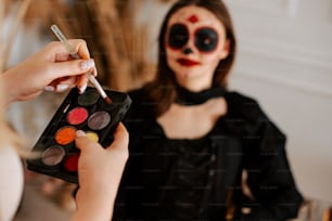 a woman is getting her make up done