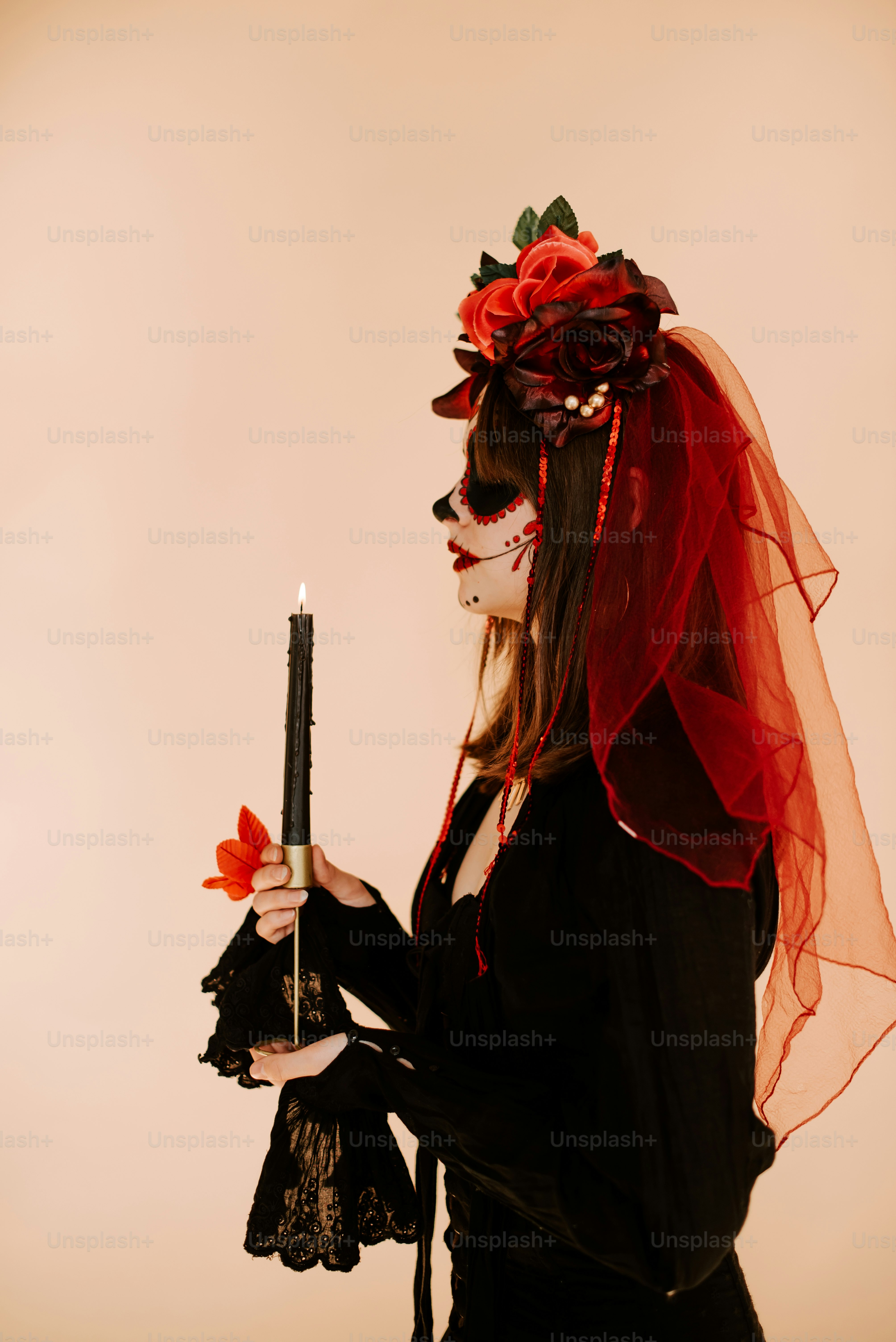 a woman in a costume holding a candle