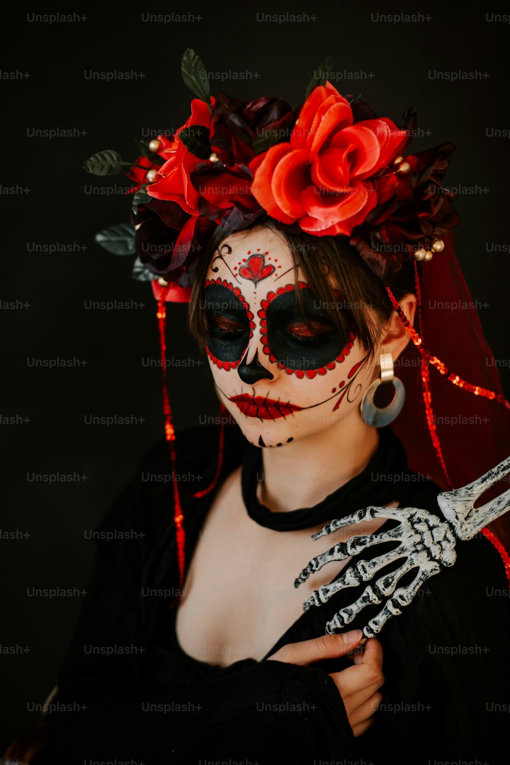 a woman wearing a skeleton makeup and holding a knife