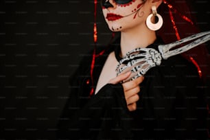 a woman in a skeleton costume holding a pair of scissors