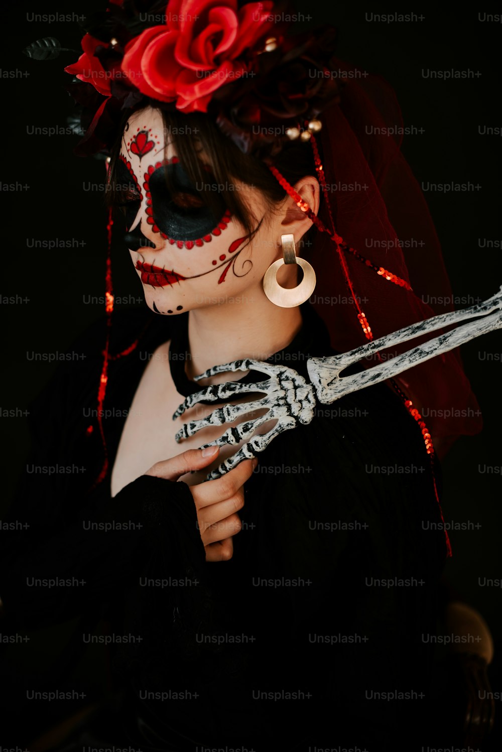 a woman in a skeleton costume holding a pair of scissors