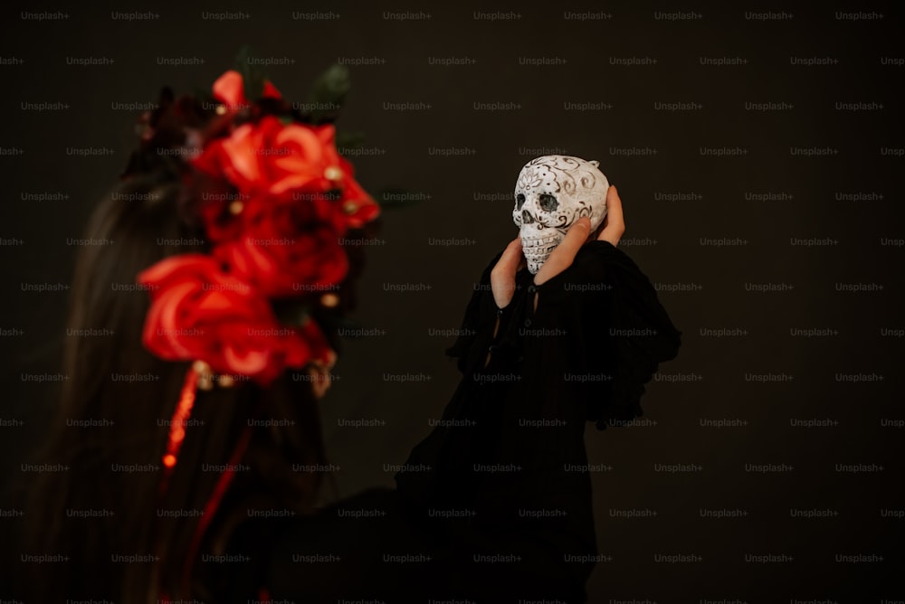 a woman with a skull mask covering her face