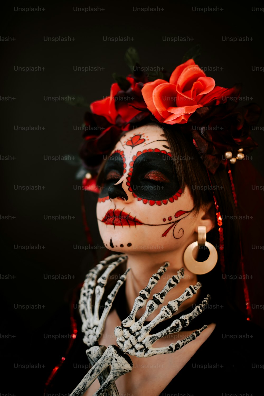 a woman with a skeleton make up and a flower in her hair