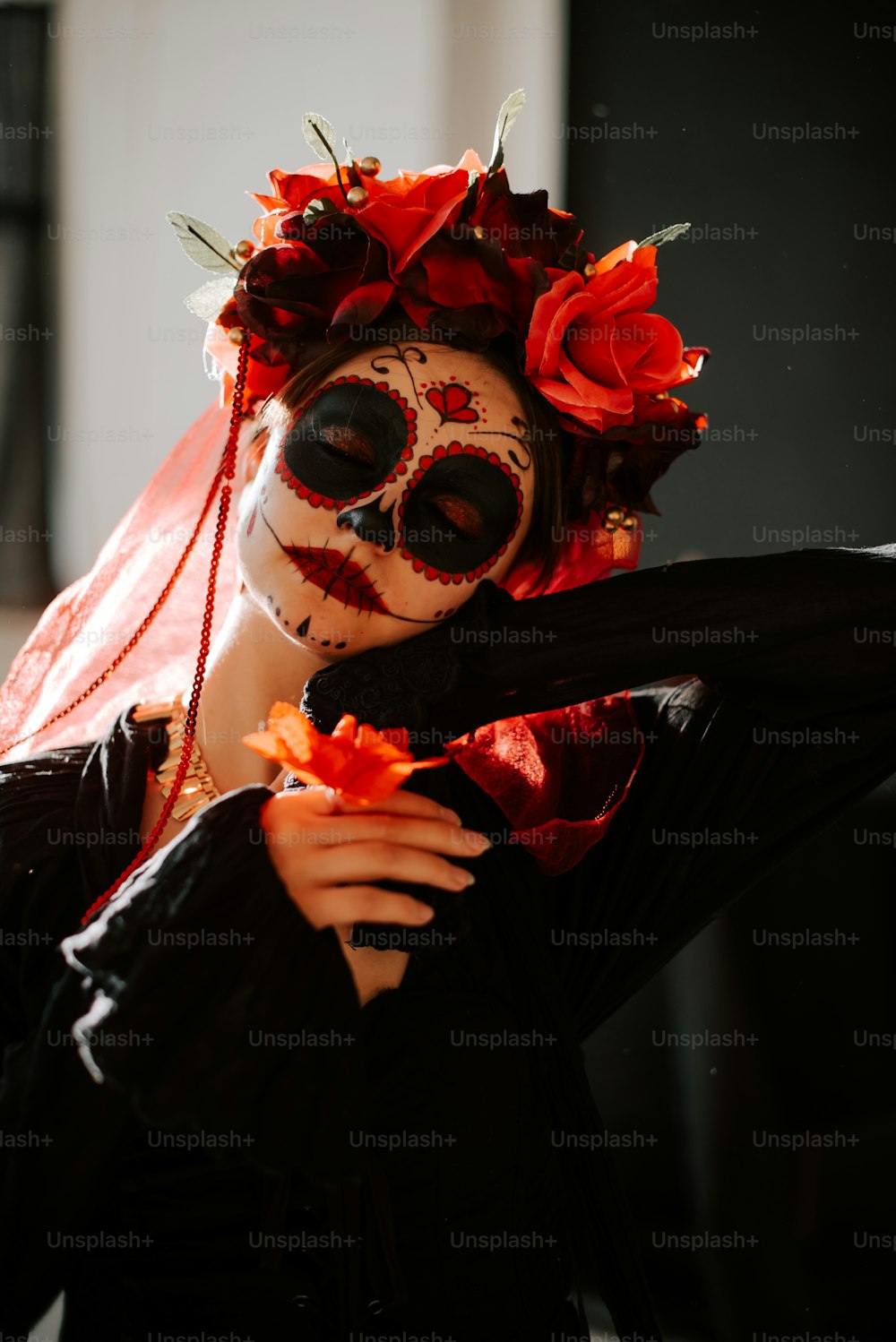 a woman wearing a skeleton mask with flowers in her hair