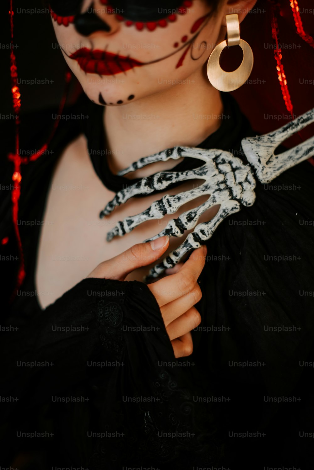 a woman wearing a skeleton costume holding a pair of scissors