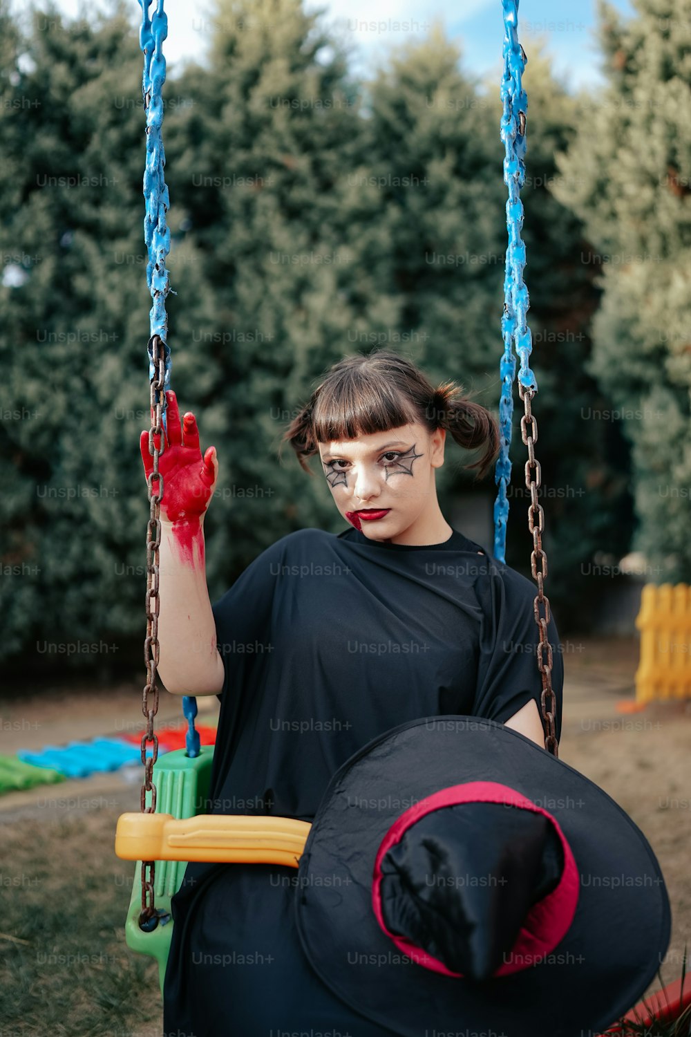 a woman in a witches costume on a swing