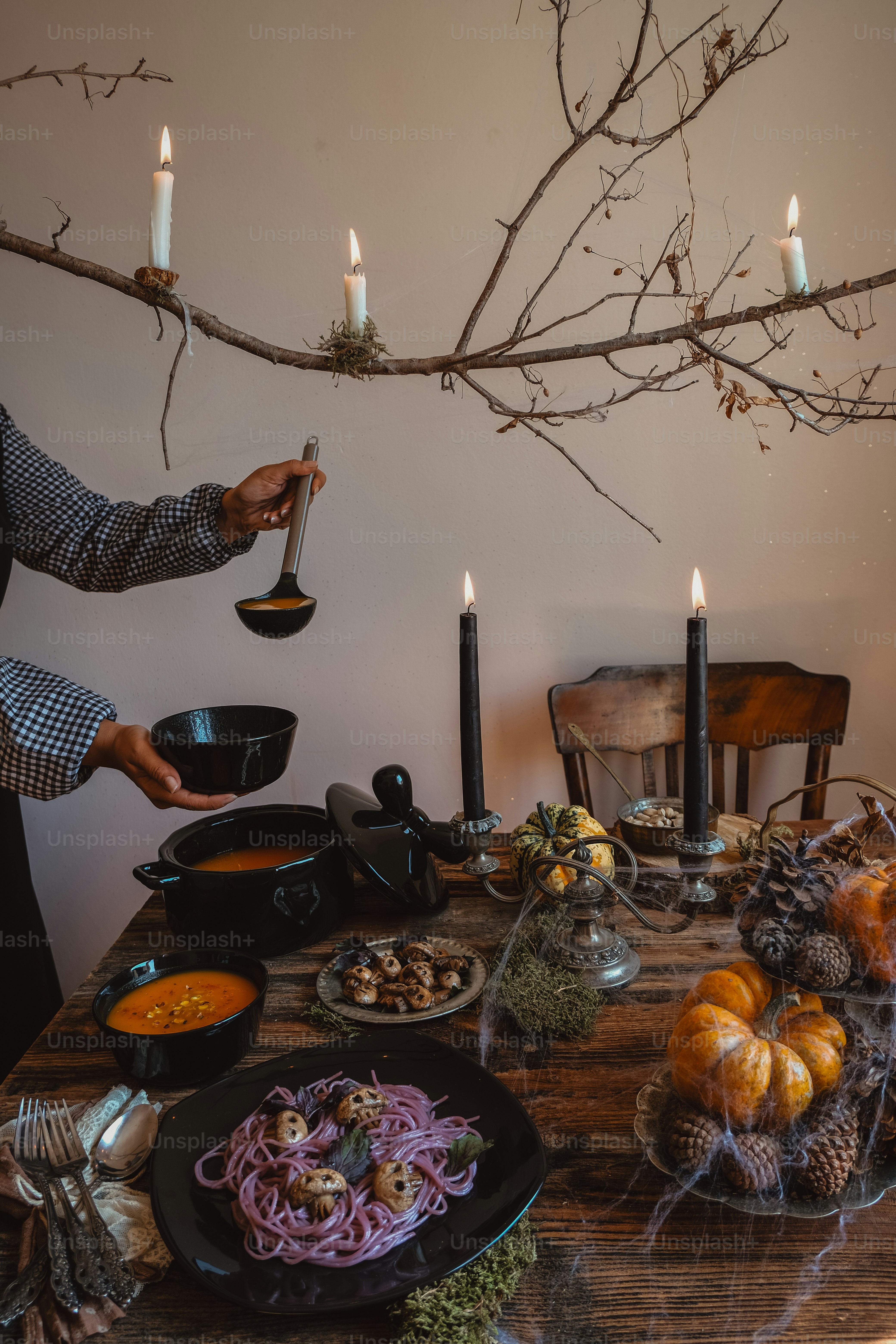 a person standing over a table filled with food