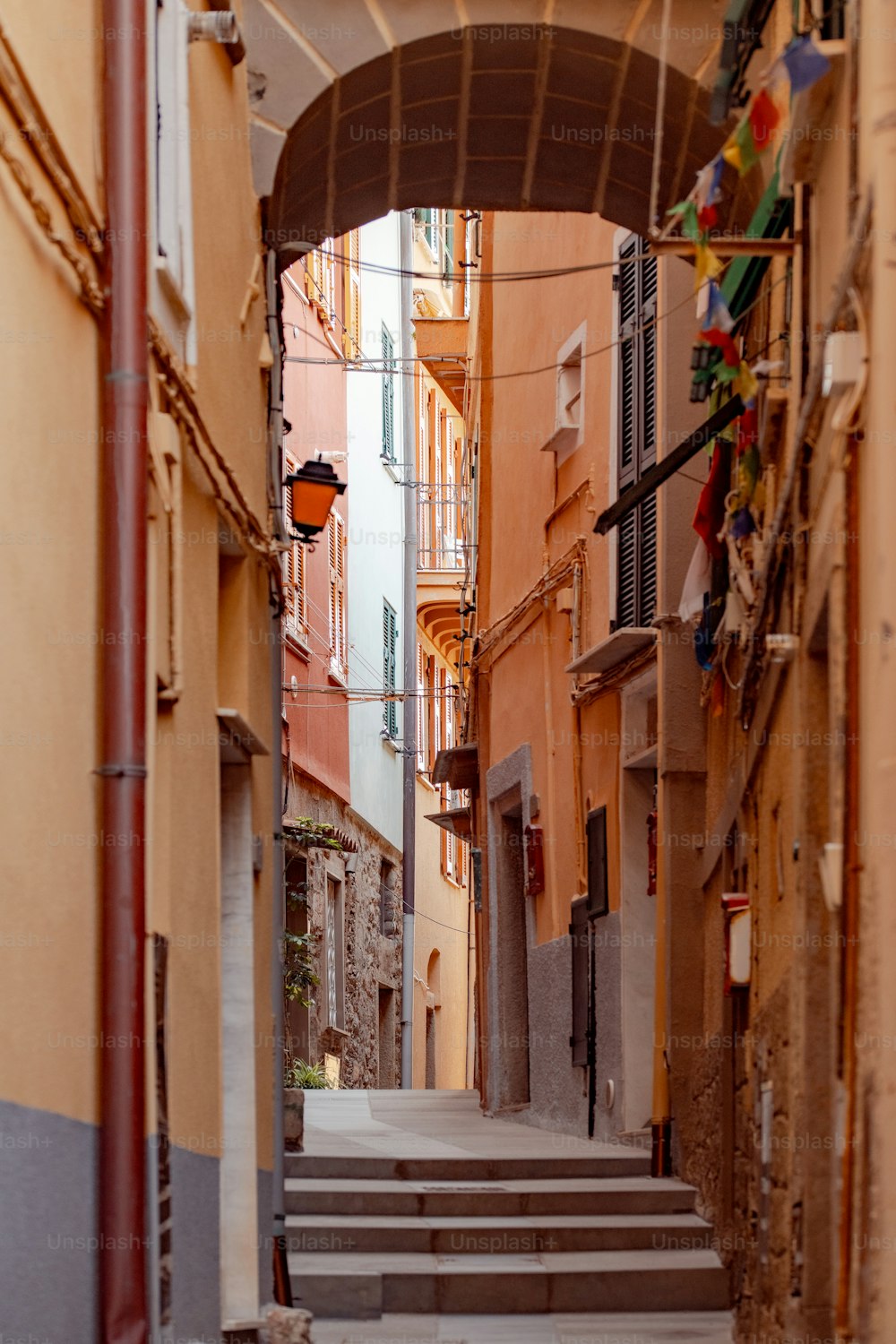 a narrow alleyway with steps leading to buildings