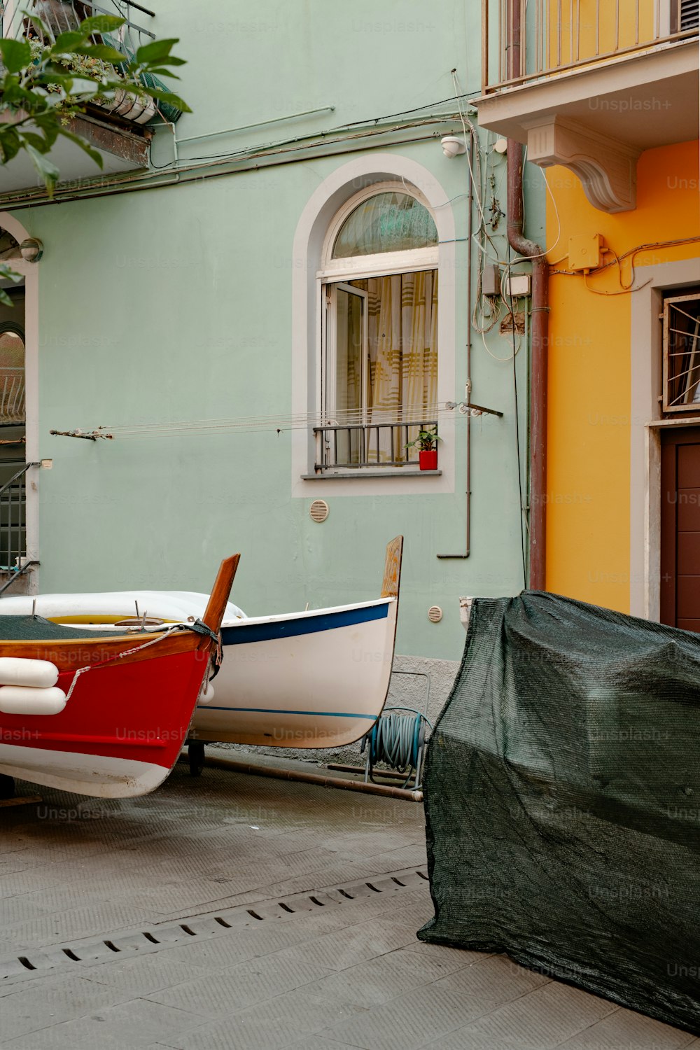 a couple of boats that are sitting in the street