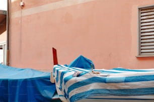 a blue and white striped blanket sitting on top of a boat